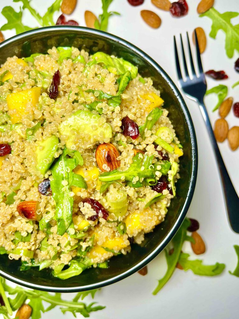 mango avocado quinoa salad in bowl with fork