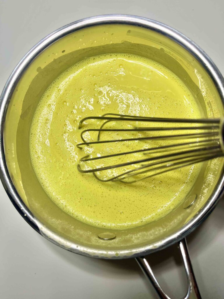 whisking the lemon pudding in a bowl