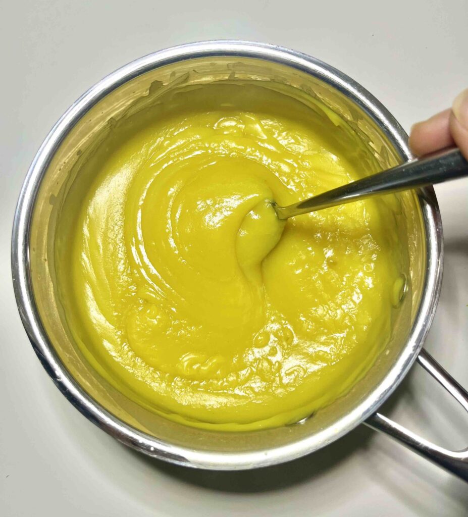 lemon pudding in pot with spoon