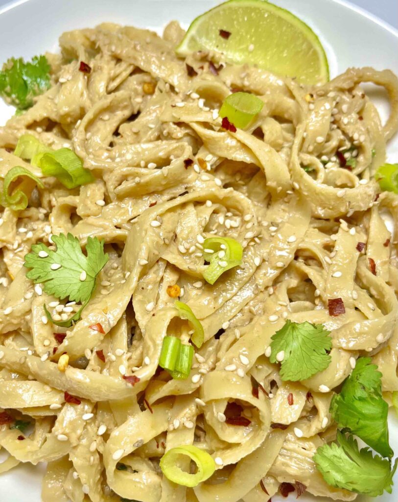 noodles with peanut sauce and garnishes
