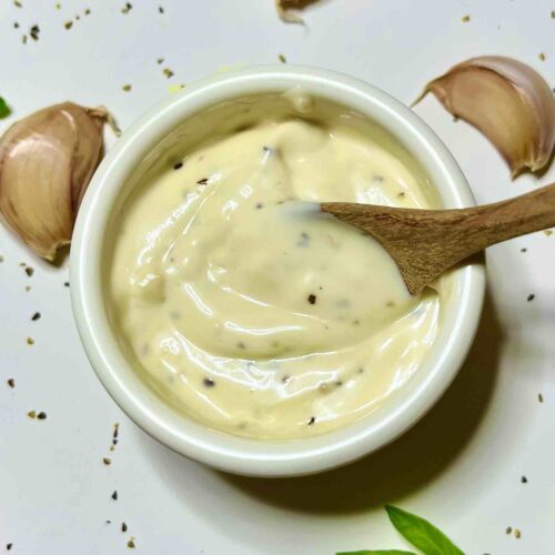 lemon garlic aioli in cup with spoon seen from top