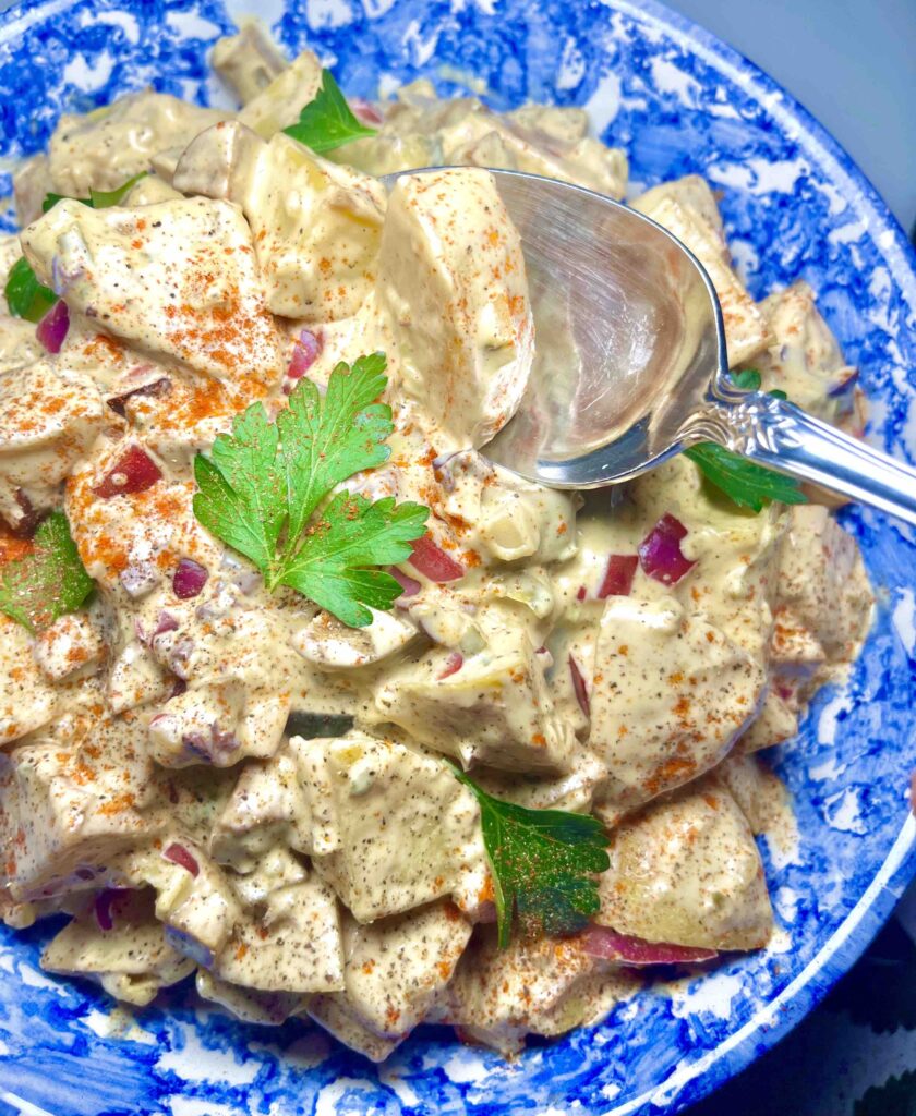 cuban potato salad in blue bowl with spoon
