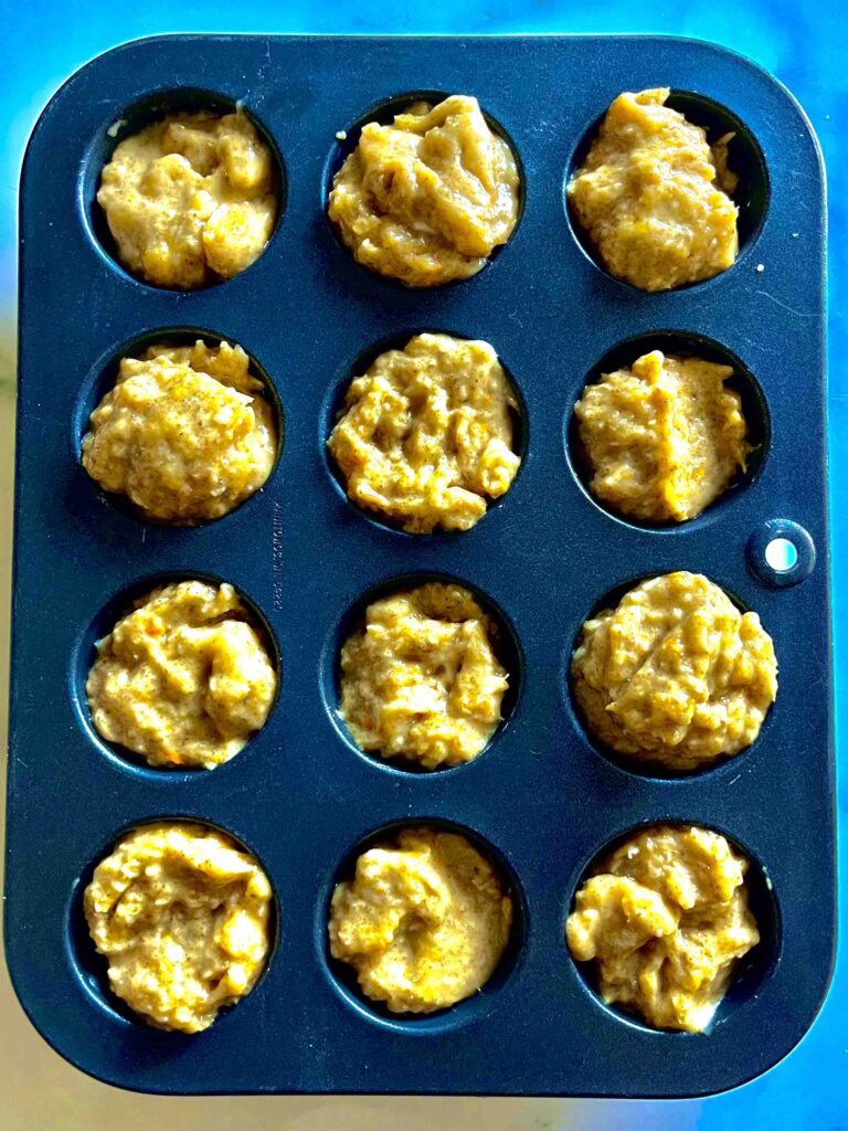 mini orange coconut muffins in pan prior to baking