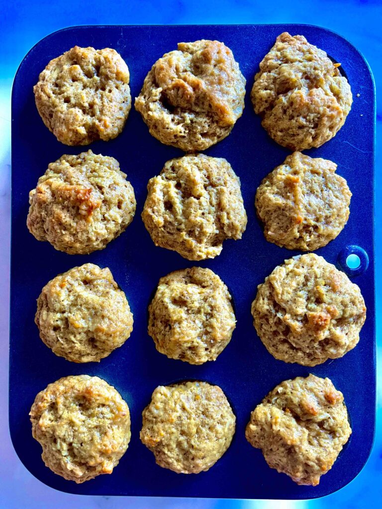 mini orange coconut muffins in pan after baking