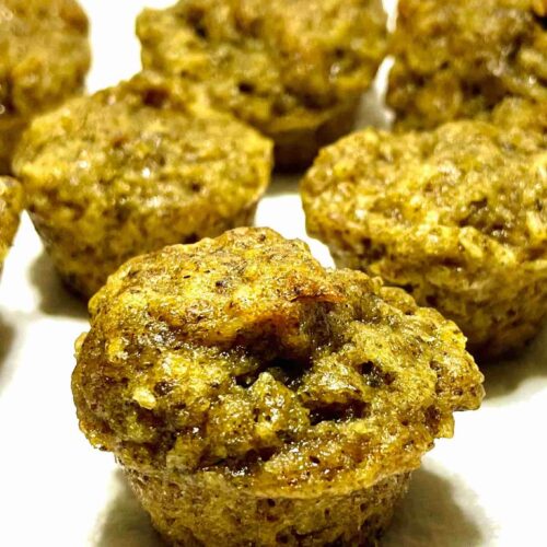 orange coconut muffins in rows against white backdrop