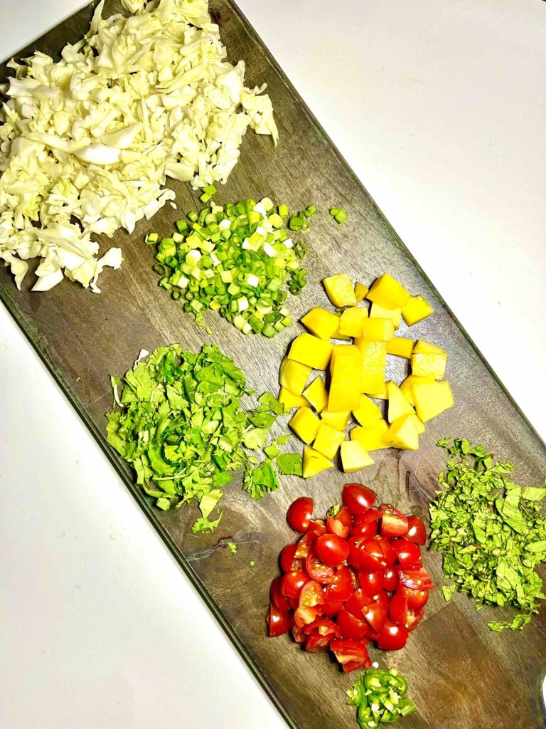 Burmese salad ingredients separated on cutting board