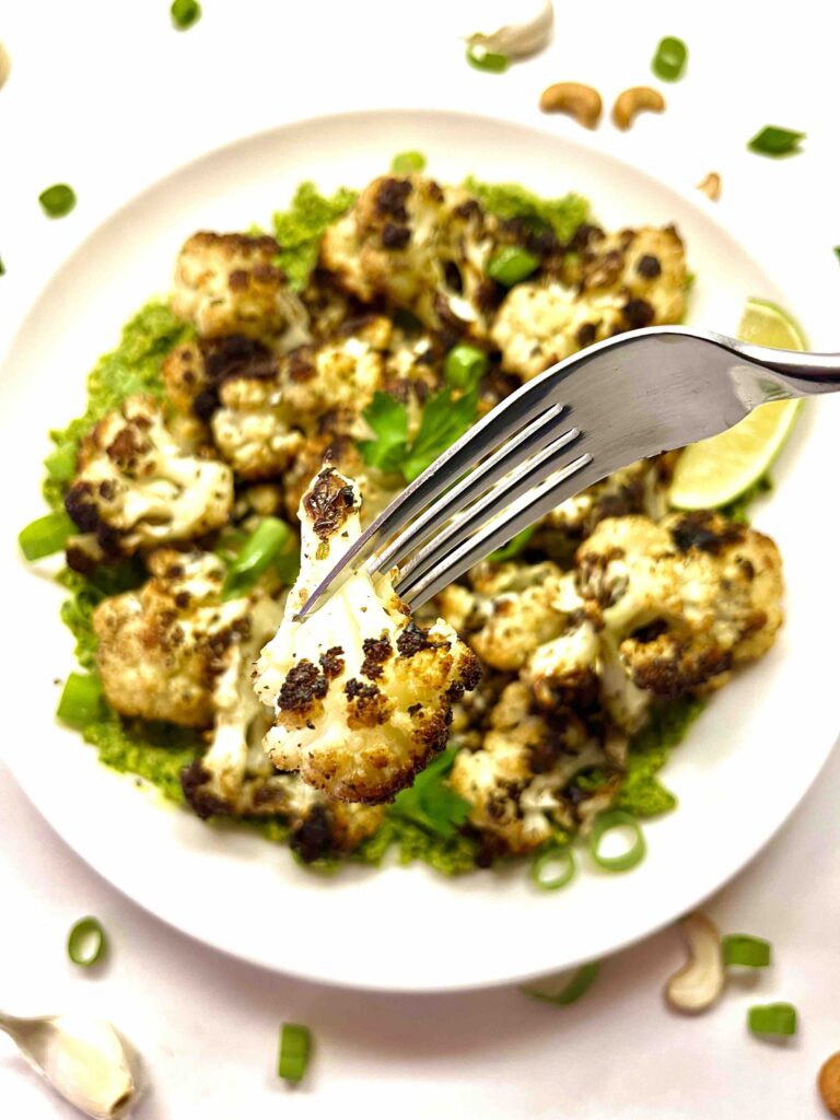 close-up of roasted cauliflower on plate with fork