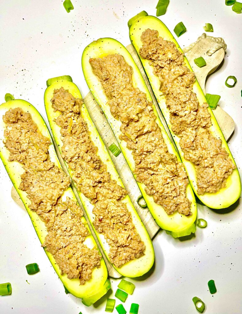 stuffed zucchini boats on cutting board