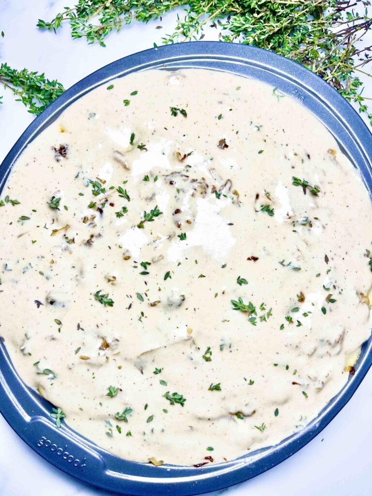 pan of creamy scalloped potatoes before baking seen from top