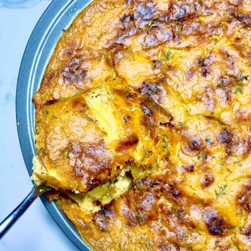 dish of vegan scalloped potatoes with spoonful