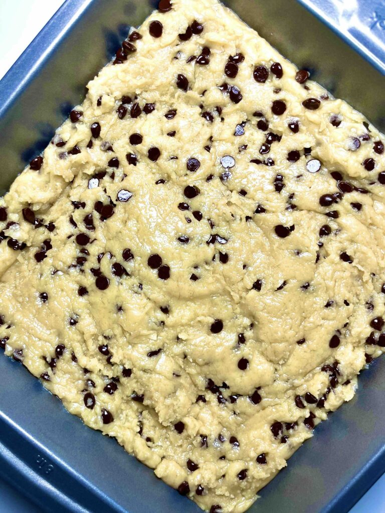 vegan chocolate chip cookie bars in baking pan before baking
