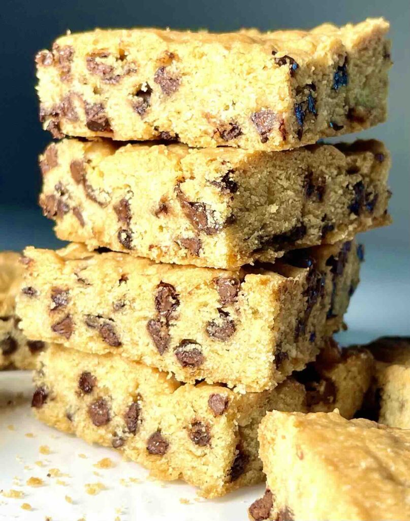 vegan chocolate chip cookie bars cut into squares and stacked in a column