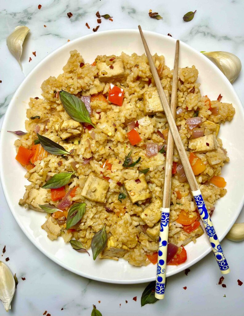 thai basil fried rice with chopsticks on plate