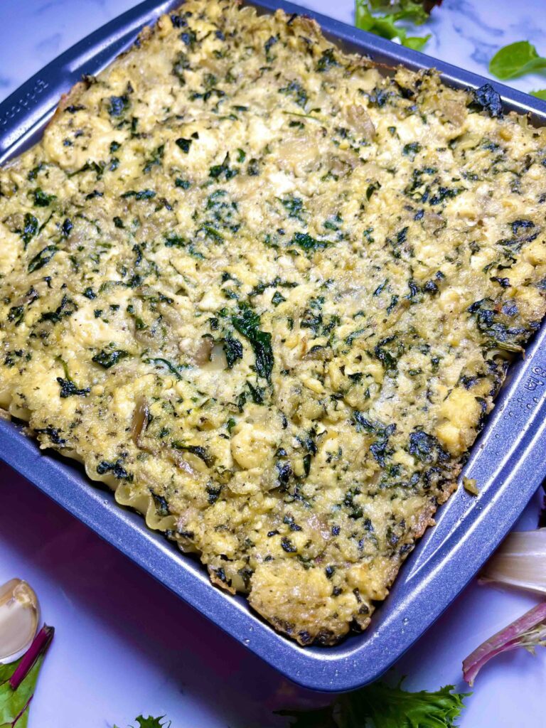 baked vegan creamy spinach mushroom lasagna in pan