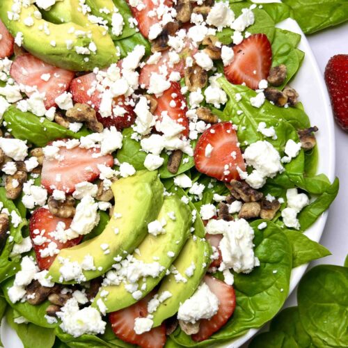 spinach strawberry salad on plate seen from above