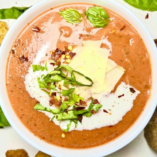 tomato bisque in bowl with garnishes seen from above