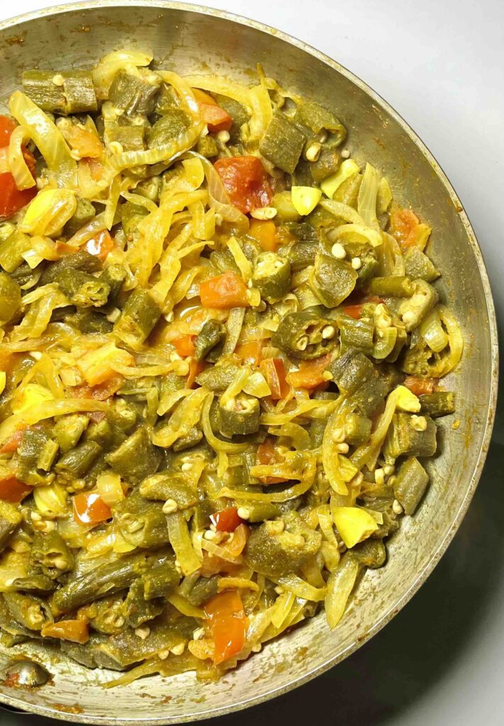 okra masala in a pan, seen overhead and in close-up