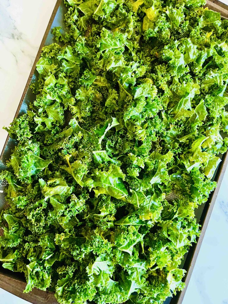 fresh kale on a baking sheet seen from above
