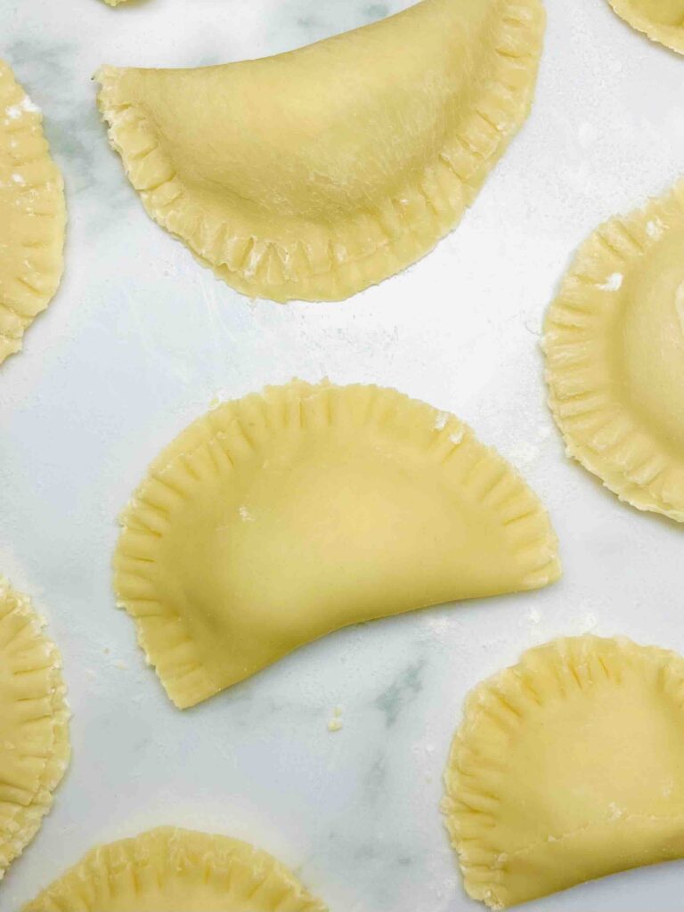 pierogi on a sheet seen from above before cooking